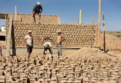 Construction workers building mudbrick house in development outside Shymkent Kazakhstan