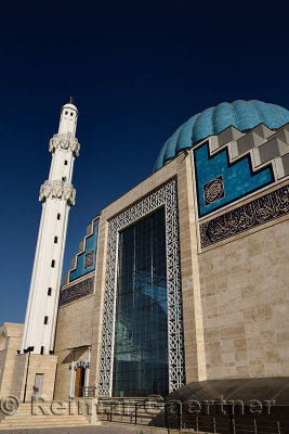 White minaret and ribbed dome of modern Hoca Ahmet Yesevi Mosque in Turkistan Kazakhstan
