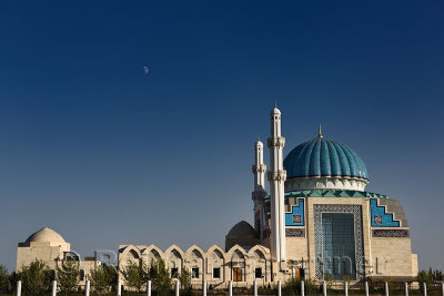 Moonrise at sunset over Hoca Ahmet Yesevi Mosque in Turkistan Kazakhstan
