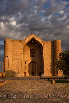 Stone square in front of Khoja Ahmed Yasawi Mausoleum in sunshine at dawn in Turkestan Kazakhstan
