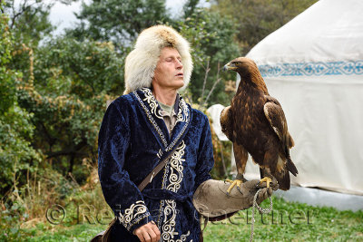 Professional trainer talking to Golden Eagle at Sunkar Raptor Center in Alma Arasan Gorge Almaty Kazakhstan