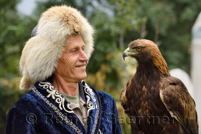 Professional trainer smiling at Golden Eagle at Sunkar Raptor Center in Alma Arasan Gorge Almaty Kazakhstan