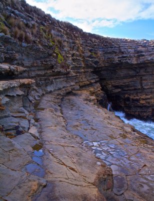 Sea carving into the cliff