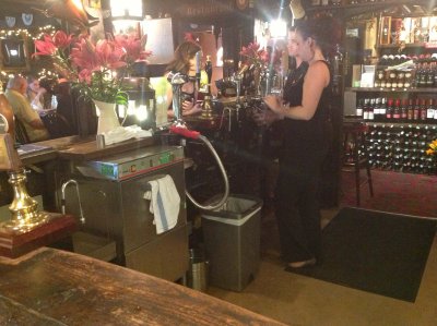 Barmaid Pulls a pint in the Nobody Inn.