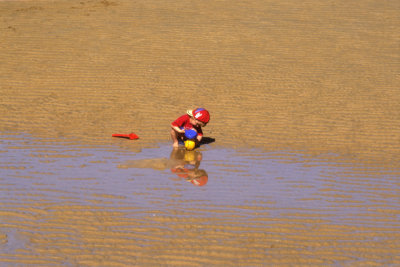 Child Playing on the Sand       