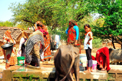 Masked Woman at the Water Well