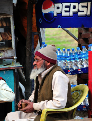 Old Muslim Gentleman Drinking Tea With Friends