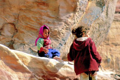 Children Playing On The Rocks Outside Their Homes 