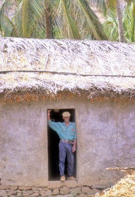 Traditional Man At The Door Of His Traditional House