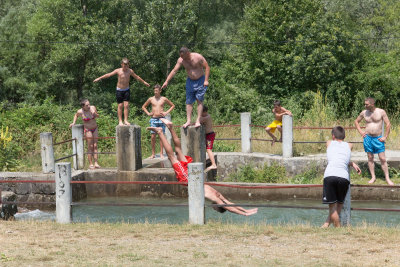 Locals bathing in the picnic area in the mountains on a hot summer day