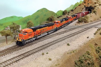 BNSF 9846 (SD70MAC) with a pair of BNSF SD70ACes emerging out of the tunnel.