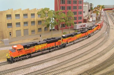 Roaring past Norwalk with grain cars in tow.
