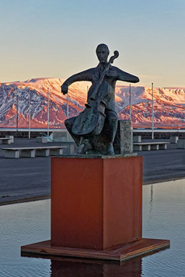 A cellist statue sits outside the Harpa Concert Hall
