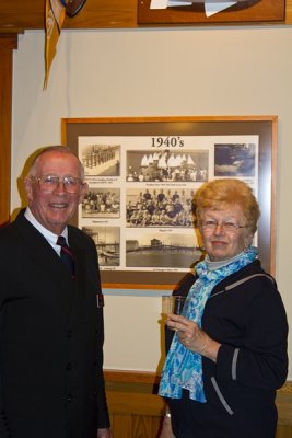 24.  Former Commodore Flagler and Barbara Zimmerman looking at a 1947 photo of Phil and his family.