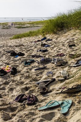 5.  Sandals resting on the sand.