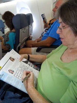 Judy enjoys(?) a game of Sudoku on our flight
