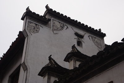 Yixian: Ming/Qing era house with painted corners and high window.