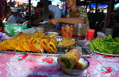 Having spring roll (foreground) with yellow pancake (background)