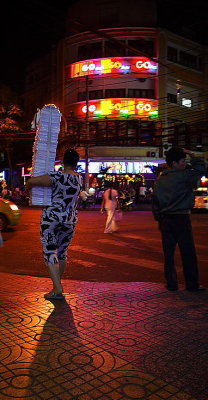 Saigon: book seller on street (yes, they walk around with stacks of books)
