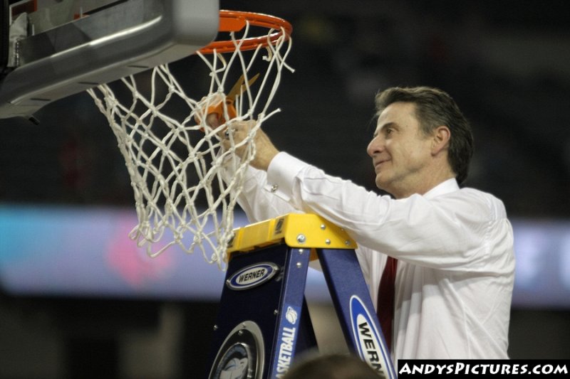 Louisville Cardinals head coach Rick Pitino cuts down the nets