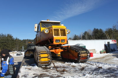 Tucker Sno-Cat up on the ramp truck with a broken rear axle