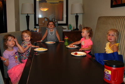 girls eating strawberries on the long table