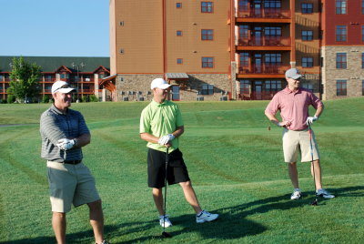 Buddy, Jarrod, and Jon watching Mike tee up his drive