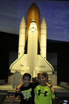 Carter and Brooks in front of the Space shuttle