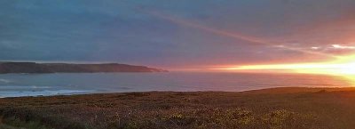 Soft light over Wideomouth Bay as the sun goes down