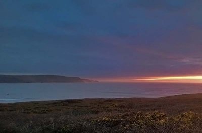 Distant sunset from Widemouth Bay