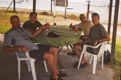 Captain, Scotty, Jamaica, and Barnacle at Palm Beach Restaurant on Petite Martinque