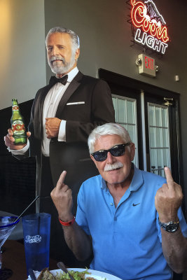 The World's Most Interesting Man seated in front of the Dos Equis guy