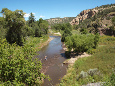 A boy and his dog in the Gila river