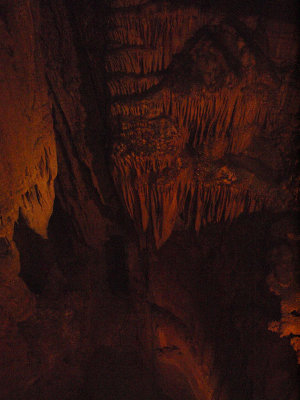 Peering into a deep hole in the cave