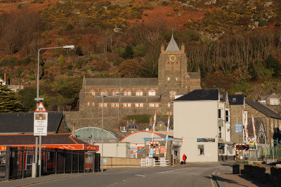 Barmouth church, railway line and a lady in red.