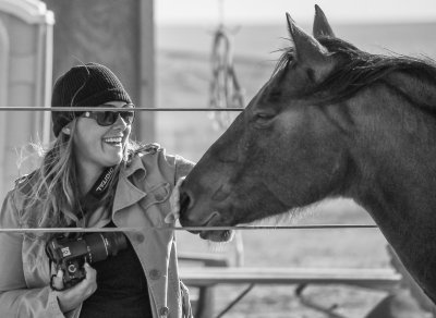 Molly Murphy interviewing and photographing a rodeo participant (2013)