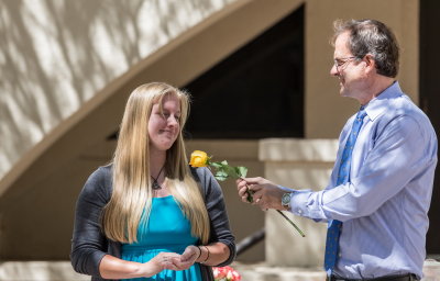 Kate Gomolak receives a rose from  Dr. Bill Walker