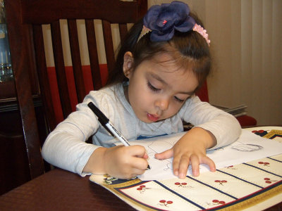 Mia busy drawing her sisters and Lola and Opa.