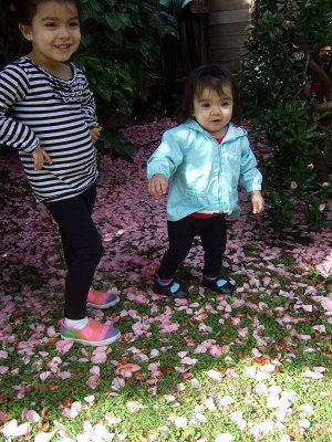 The two girls posing on the lovely camellia carpet 