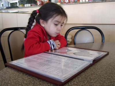 Mia trying to read the menu