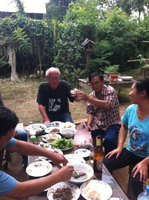 Lunch and a crate of BeerLao with my tuktuk drivers cheerful family