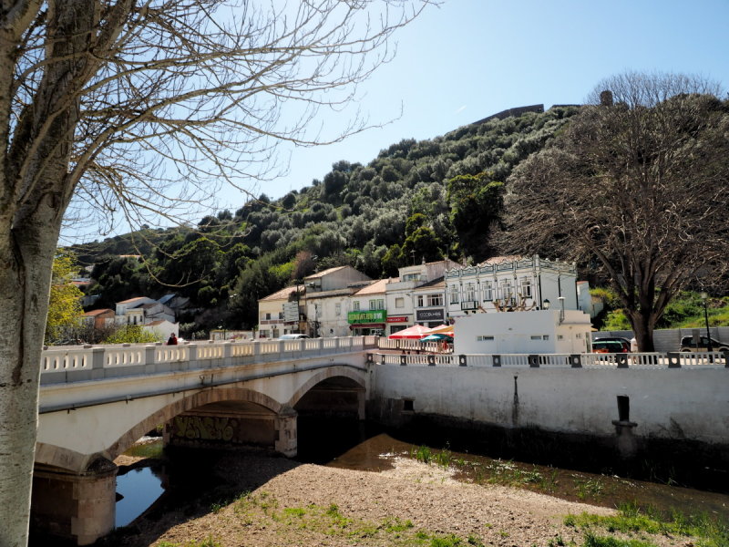 Old town with stone bridge  and castle on hill