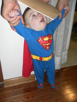 Superbaby gets measured on the door frame