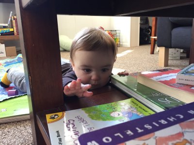 Jack uses his crawling prowess to check out his book selection under the coffee table