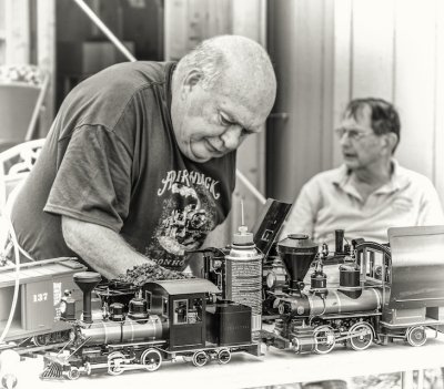 old guys playing with old style trains