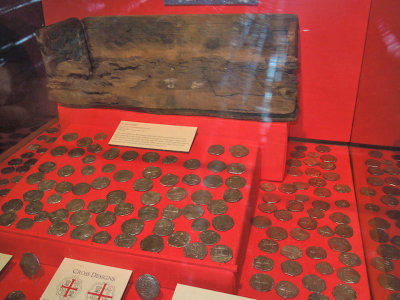 Silver coins and one of the wooden chests that were filled to overflowing