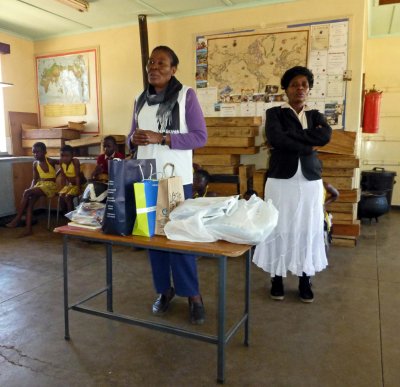 School Teachers Accept School Supplies from Our Group