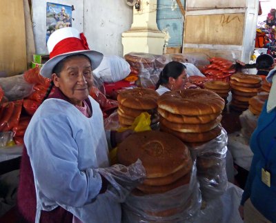 Buying Chuta Bread from Woman in Traditional Cusco White Hat