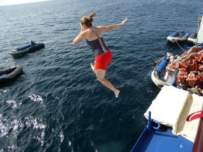 People Jumping from Top Deck of Ship