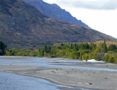 Jetboats take tourists on the braided Shotover River in New Zealand
